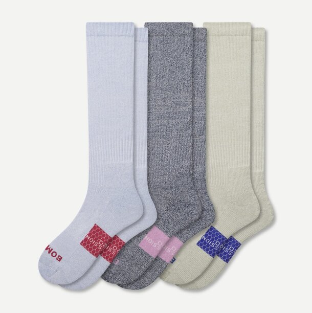 Three pairs of striped socks in blue, pink, and white, arranged neatly for display.