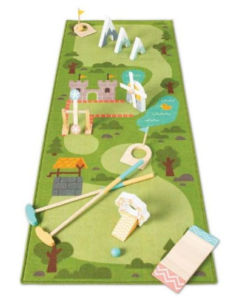 A colorful toy golf course featuring a wooden tee, golf ball, and various miniature accessories for play.