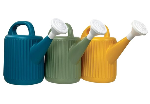 Three colorful watering cans with handles, displayed in a row, showcasing vibrant hues of red, blue, and green.