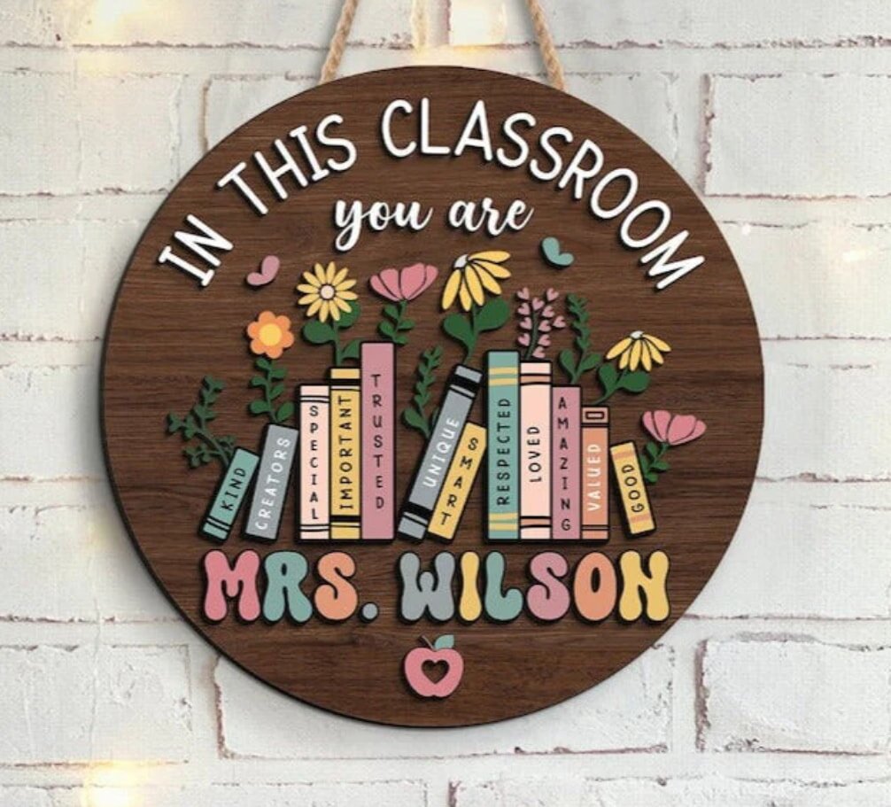 Wooden classroom sign with colorful books and flowers