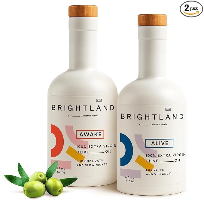 Two bottles of Colavita extra virgin olive oil displayed side by side on a neutral background.