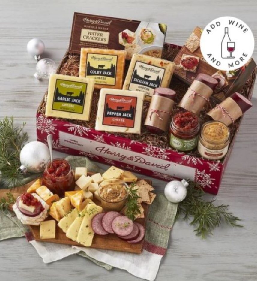 An elegant gift box containing assorted old wines and gourmet cheeses, beautifully arranged for a sophisticated presentation.