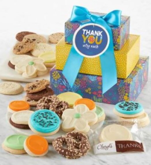 Colorful gift boxes with a "Thank You" tag, topped with a blue ribbon, surrounded by an assortment of decorative cookies in various shapes and colors.