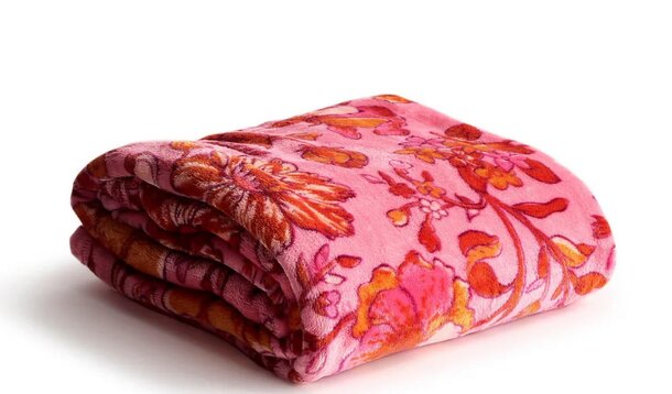 A man stands beside his bike, which is equipped with a light, ready for a ride in the evening.