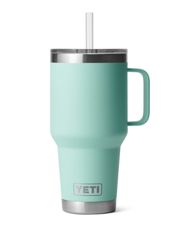 Mint green Yeti tumbler with a straw, designed for keeping beverages cold or hot.