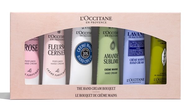 L'Occitane hand cream set in a box, featuring six colorful tubes with scents like rose and lavender, labeled "The Hand Cream Bouquet.