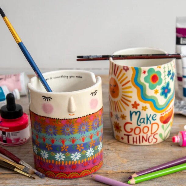 A pottery mug surrounded by crafting materials, symbolizing creativity and the joy of making good things.