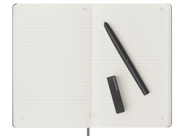 A notebook with a pen and a black pen resting on top, showcasing a simple writing setup.