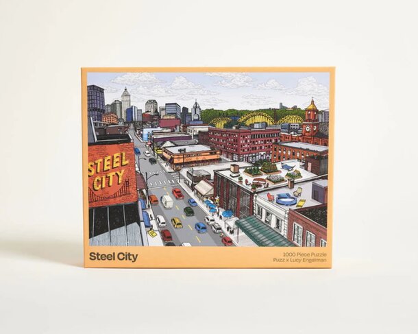 A box of colorful puzzle pieces featuring a detailed city skyline design on the lid.