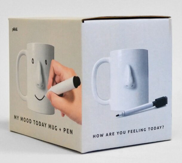 A box containing a mug and a pen, arranged neatly for presentation.