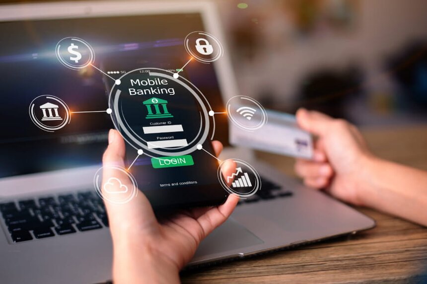 Mobile banking concept featuring a smartphone displaying financial apps and digital transactions on a desk.