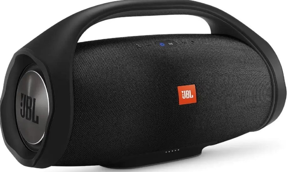 A sleek black portable speaker with a built-in handle, featuring the JBL logo in orange. Its modern design conveys functionality and style.