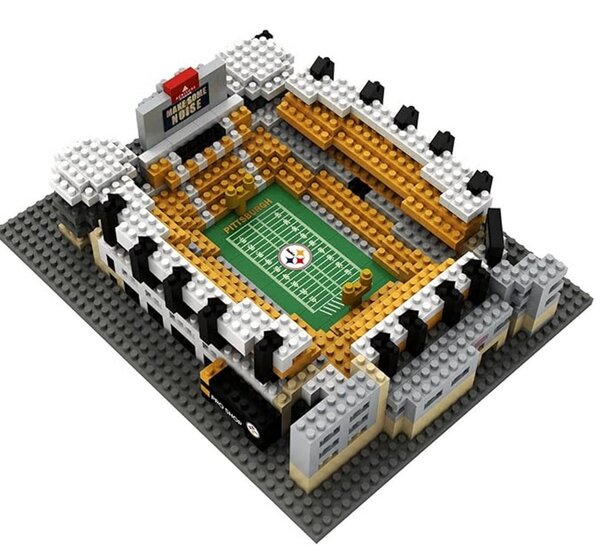 A detailed LEGO stadium featuring a football field, complete with goalposts and seating for fans.