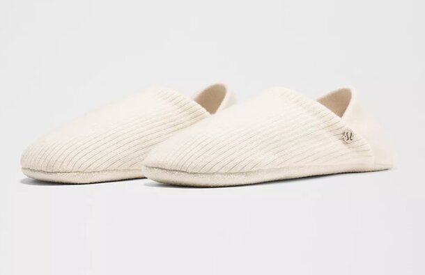 Soft, knitted fabric slippers, showcasing a cozy and comfortable design ideal for indoor wear.