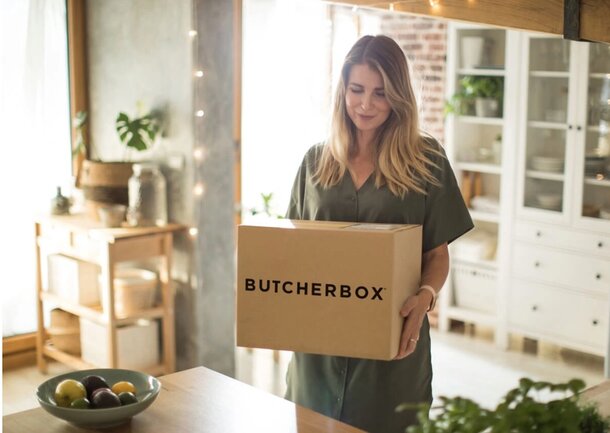 woman carrying a butcher box delivery box