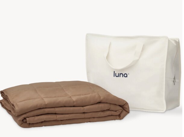Luna blanket draped over a stylish tote bag, showcasing a cozy and fashionable combination for outdoor activities.