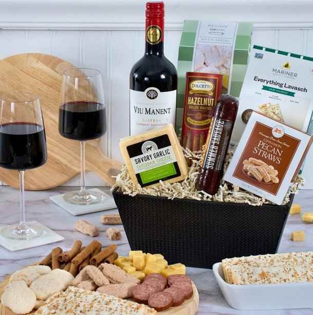 A gift basket featuring wine, assorted cheeses, and a variety of crackers elegantly arranged for a delightful presentation.