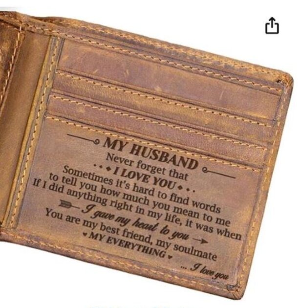 A leather wallet with the phrase "my husband never leaves me" embossed on it, symbolizing love and commitment.