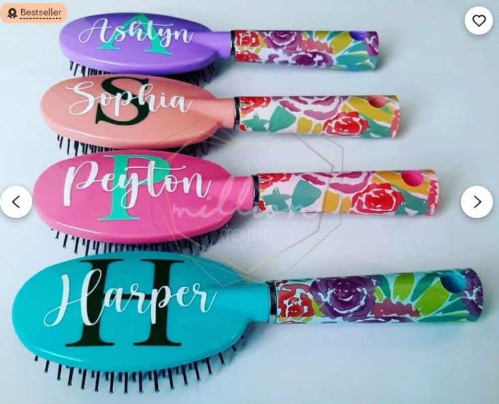 Personalized hair brush adorned with floral designs and custom initials, showcasing a unique and elegant touch.