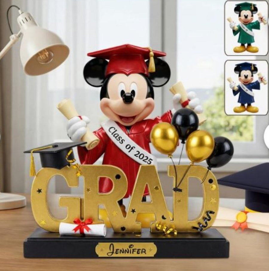 Graduation-themed Mickey Mouse figurine wearing a cap and gown, holding a diploma, celebrating academic achievement.
