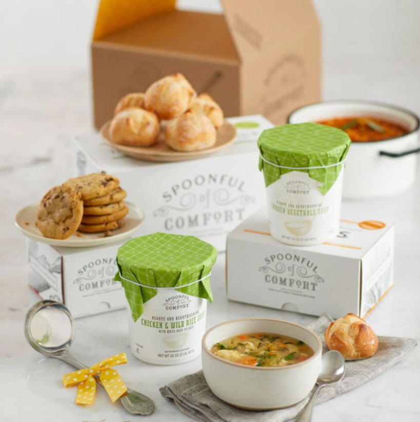 A box containing an assortment of soups and cookies, showcasing a variety of flavors and textures.