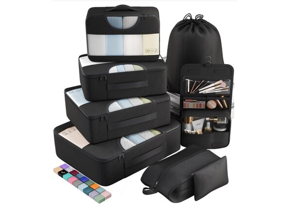 A set of black luggage filled with various travel items, including clothing and accessories, arranged neatly.