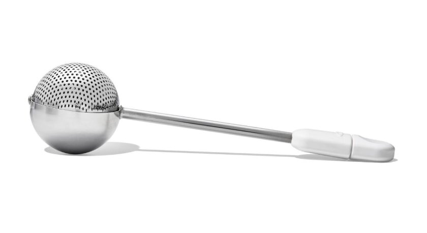 A stainless steel tea strainer featuring a handle, designed for brewing loose leaf tea.