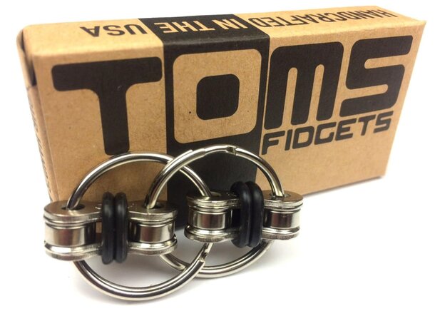 Black fidget spinner by Tom, featuring a sleek design and smooth spinning motion.