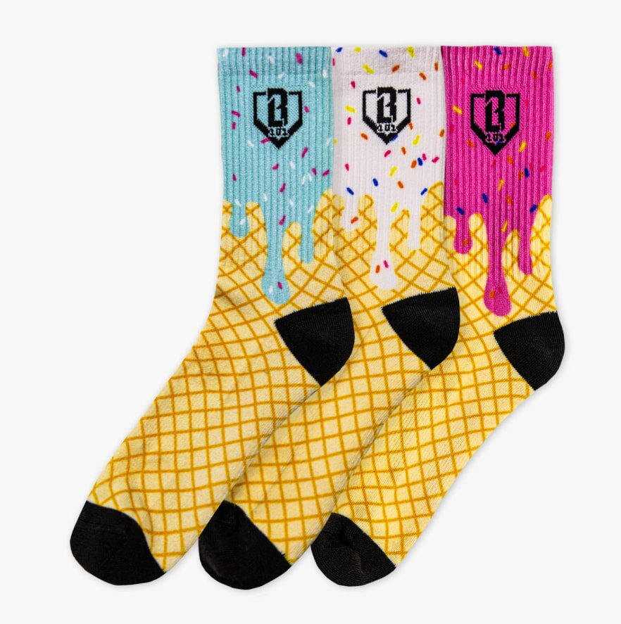 Three colorful socks designed like ice cream cones with dripping scoops. Blue, white, and pink tops have sprinkles, black toes and heels, playful tone.