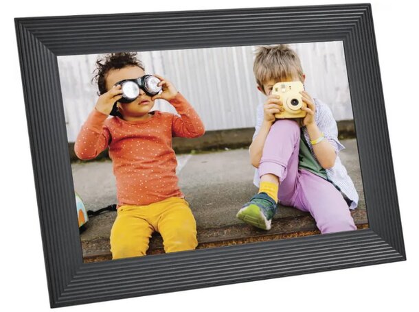Two children smiling at the camera, framed in a simple black border.