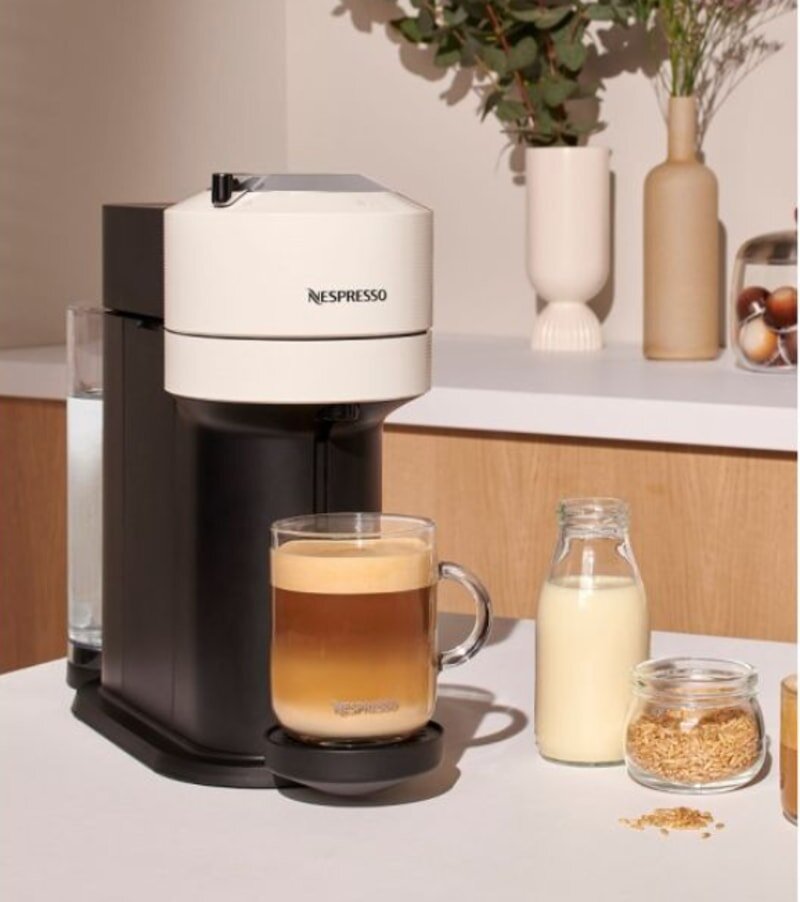 White Nespresso machine with a sleek design, showcasing modern aesthetics and functionality.