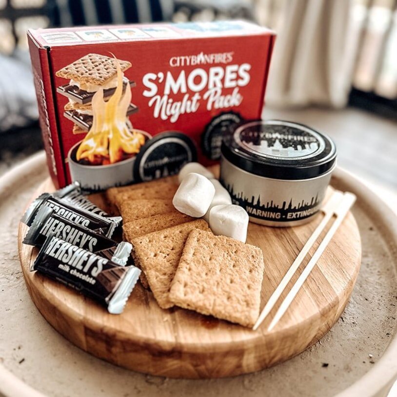 A tray displaying marshmallows, crackers, and a box of s'mores ingredients, ready for a fun treat assembly.