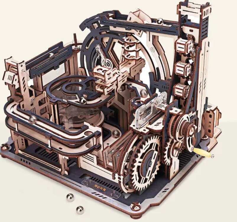 A detailed wooden model of a machine featuring intricate gears and wheels, showcasing craftsmanship and mechanical design.