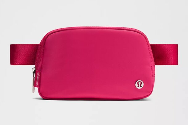 A pink fanny bag featuring a front zipper, ideal for casual outings and hands-free convenience.