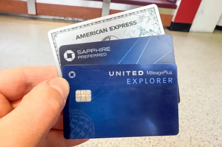 A person holding a United Explorer Card, showcasing the front design and their hand gripping the card firmly.