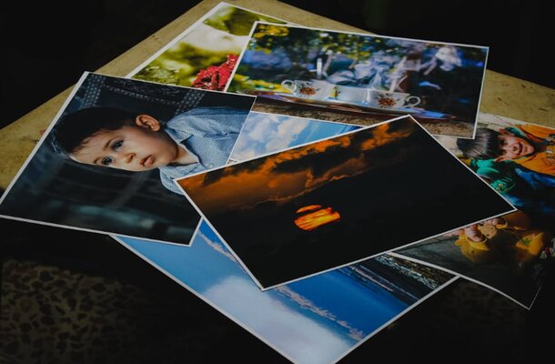 A table featuring an assortment of children's photos, capturing their happiness and diverse experiences.