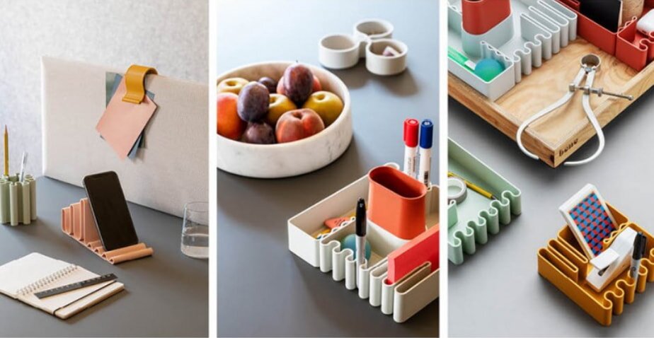 A collage of organized desk setups: left shows a phone holder and notepad; center has a tray with fruit and pens; right features stationery in a wavy, modular organizer.