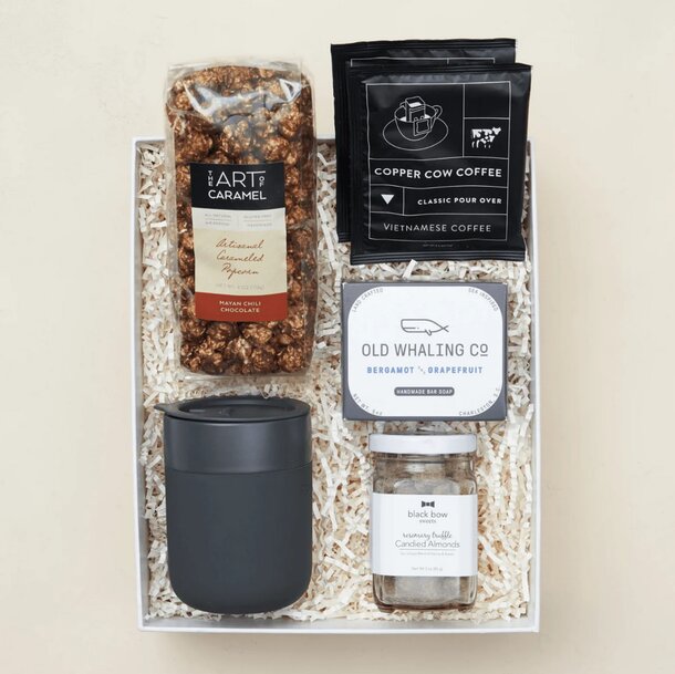 A gift box containing an assortment of coffee, tea, and snacks for a delightful beverage experience.