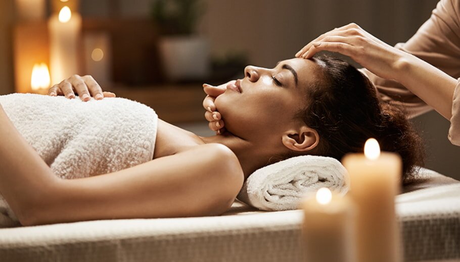 Woman receiving facial massage at spa