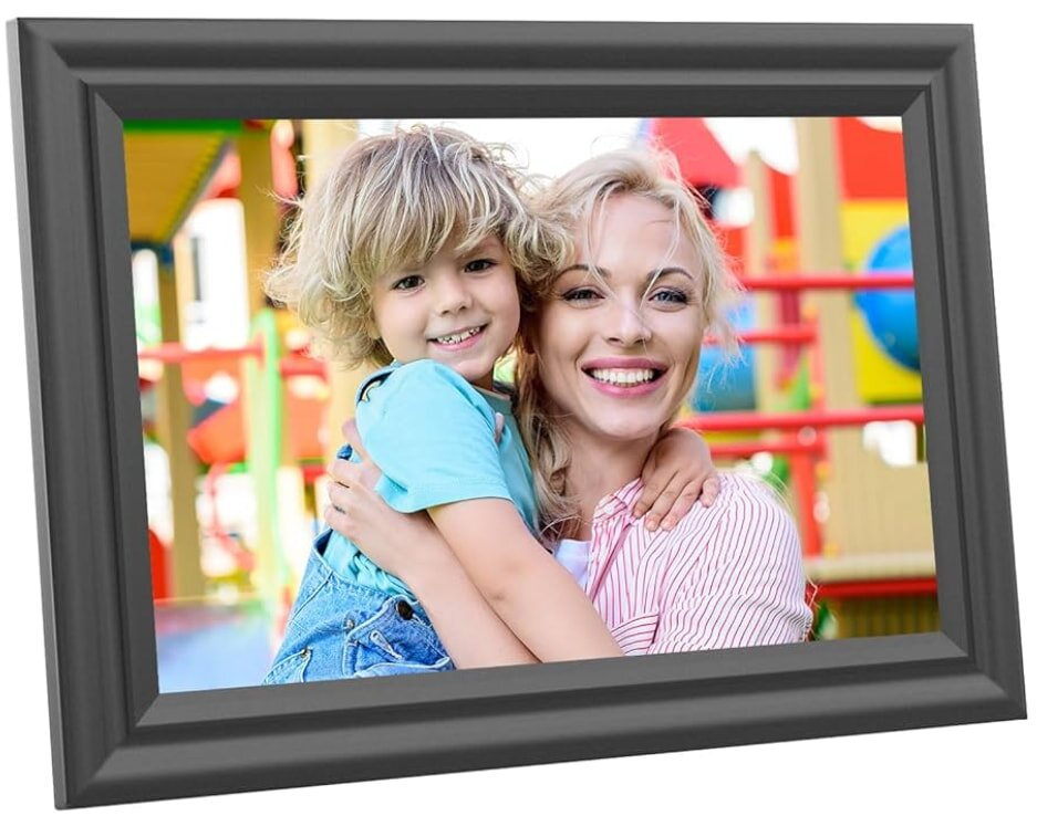 A mother joyfully embraces her smiling child at a colorful playground, captured in a grey-framed photo. They convey warmth and happiness.