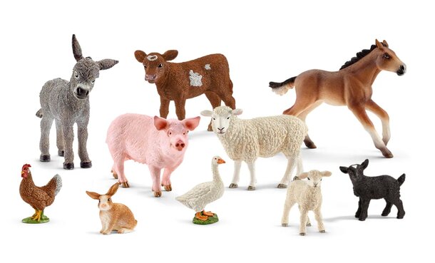 A collection of toy animals including a horse, cow, pig, donkey, goat, and sheep arranged together on a surface.