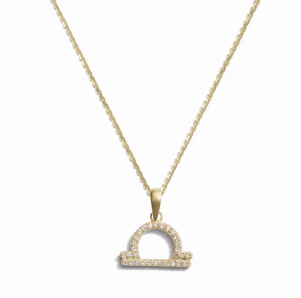Gold zodiac sign necklace adorned with sparkling diamonds, showcasing elegance and personal significance.