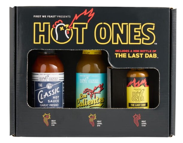 A gift box featuring various hot sauces from the "Hot Ones" series, designed for spice enthusiasts and fans of the show.