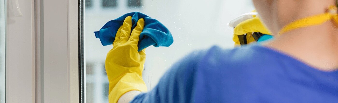 person cleaning window