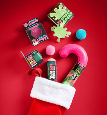 Stocking stuffer gift ideas coming out of a red and white Christmas stocking