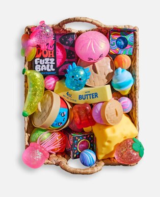 Woven basket filled with colorful sensory toys, squishies, fidget toys, and playful stocking stuffers.