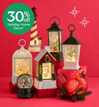 Glitter lanterns and snowglobes lit up in front of a red background