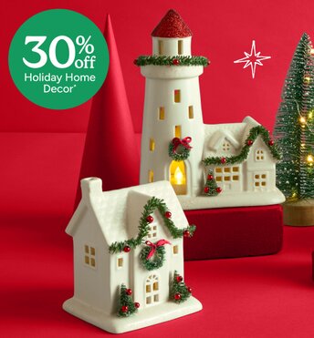Festive holiday decor houses lit up in front of a red background. 30% off holiday home decor