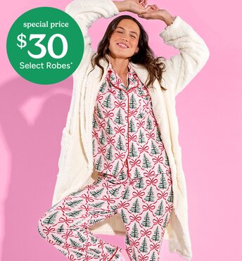 A girl wearing cozy pink pajamas with a white robe. special price $30 select robes* 