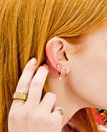 Close-up of a woman wearing gold earrings